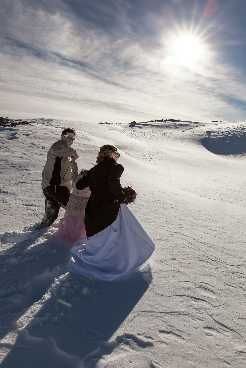 destination wedding couple walking on snow