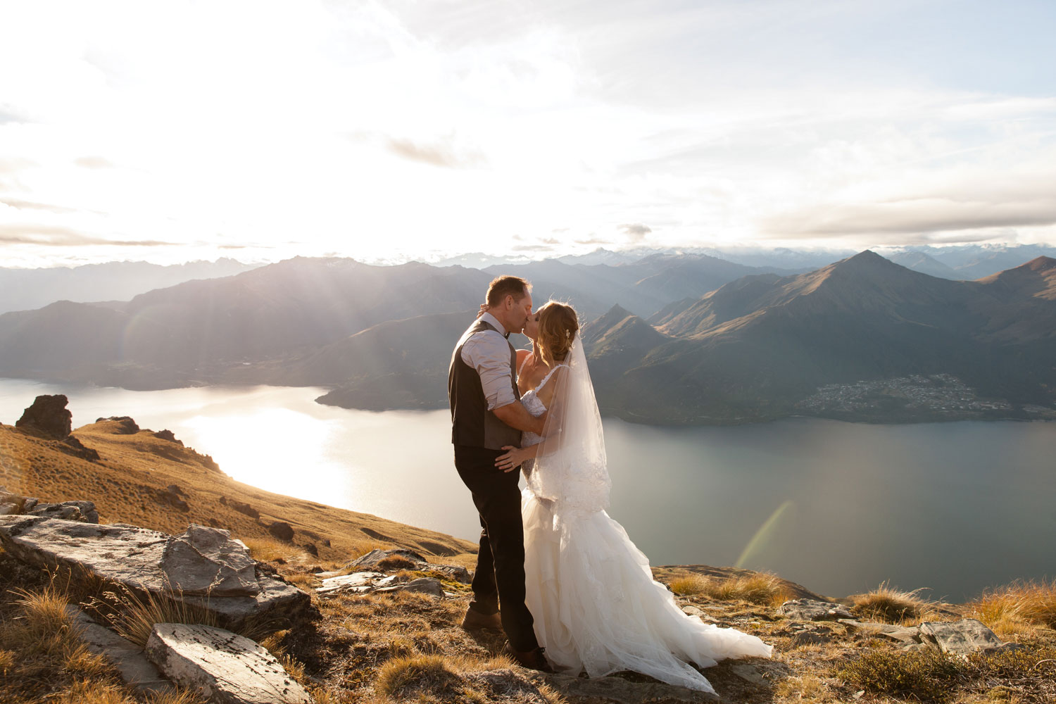 destination wedding couple kiss on mountain