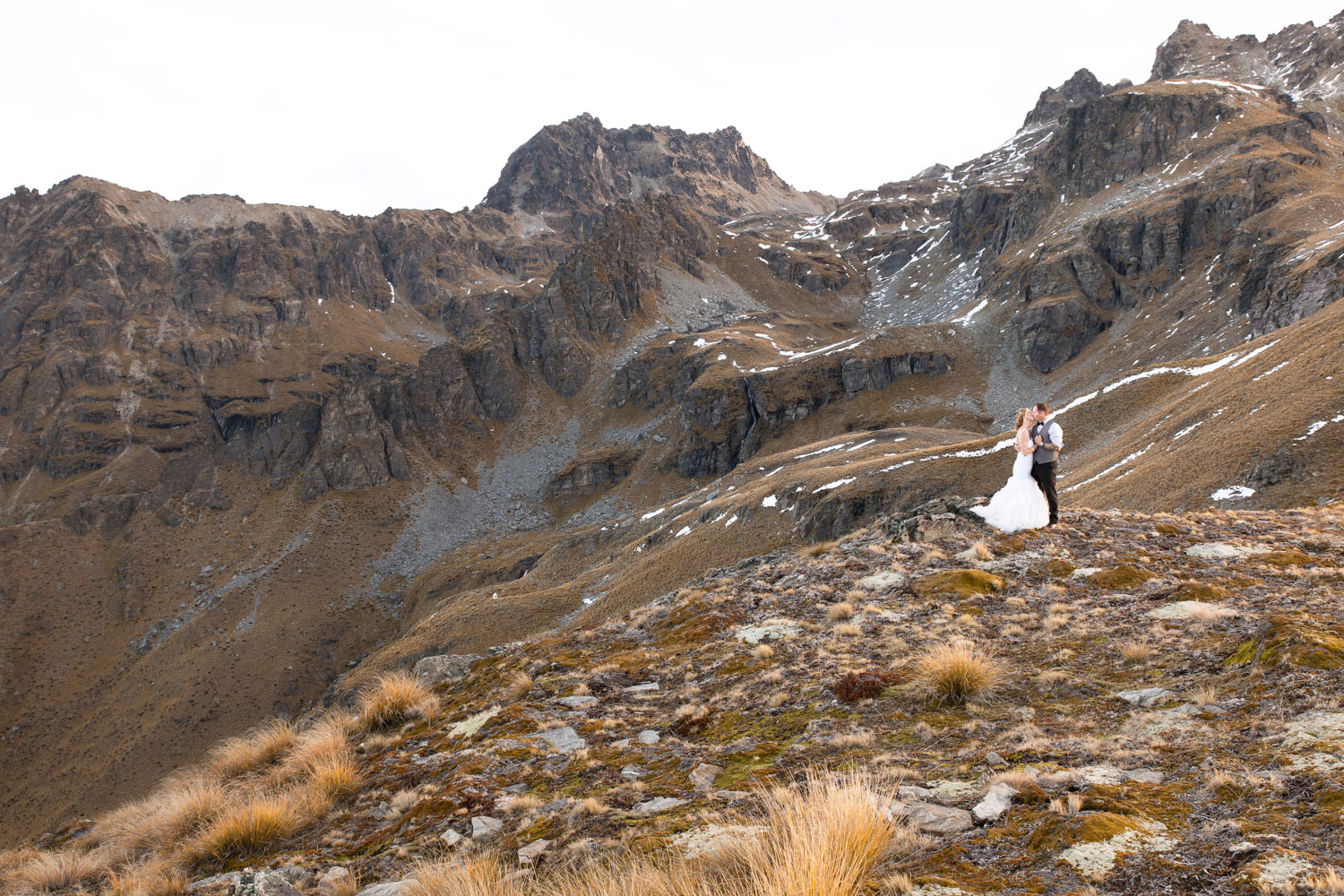 destination wedding couple standing on mountain
