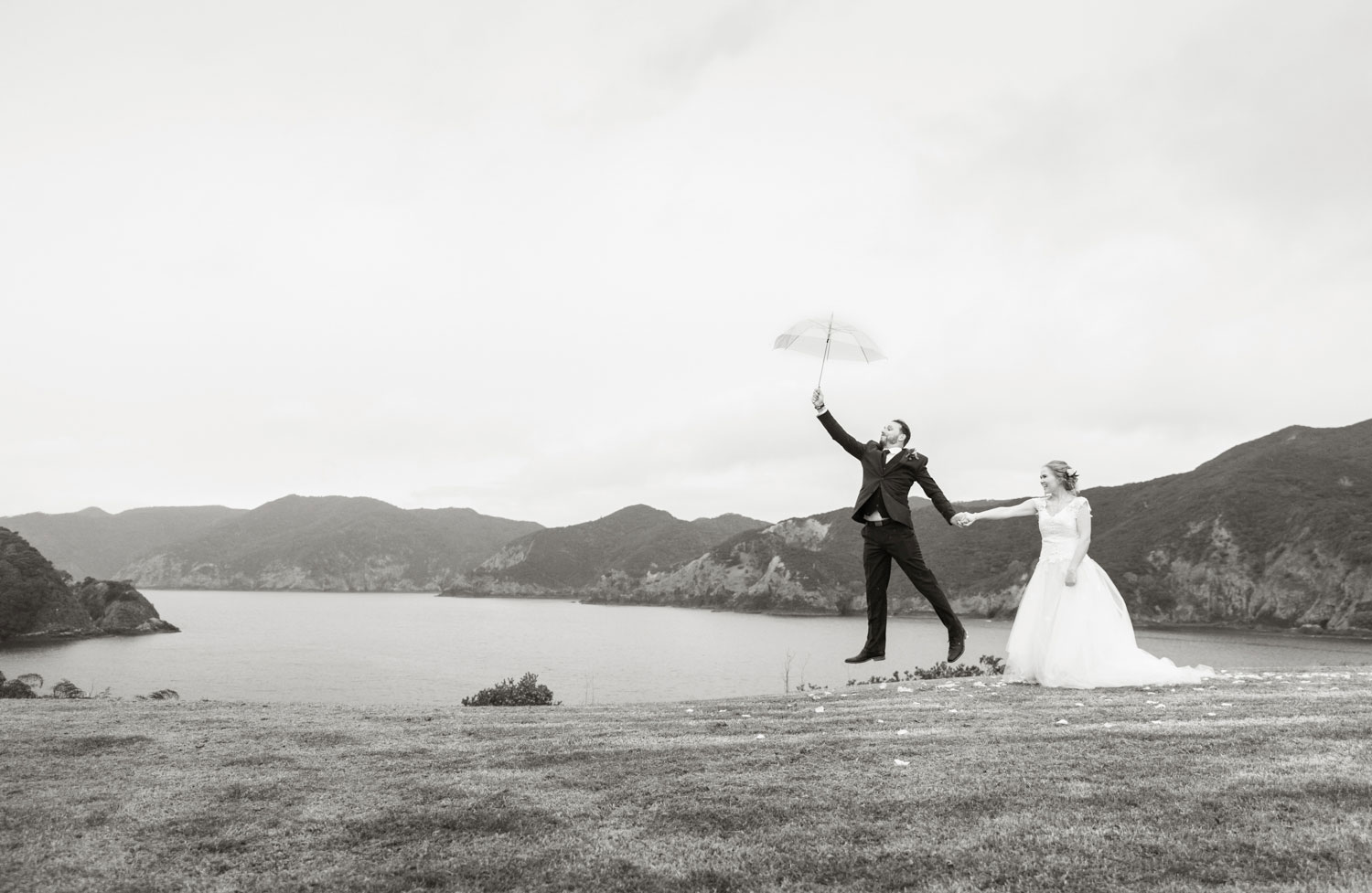 bay of islands wedding bride and groom jump