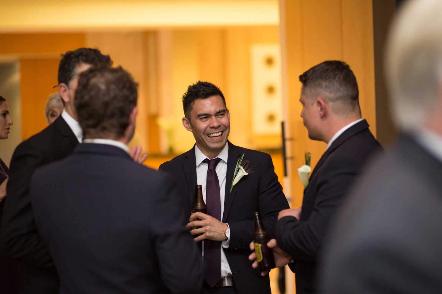 groomsmen mingling at wedding reception