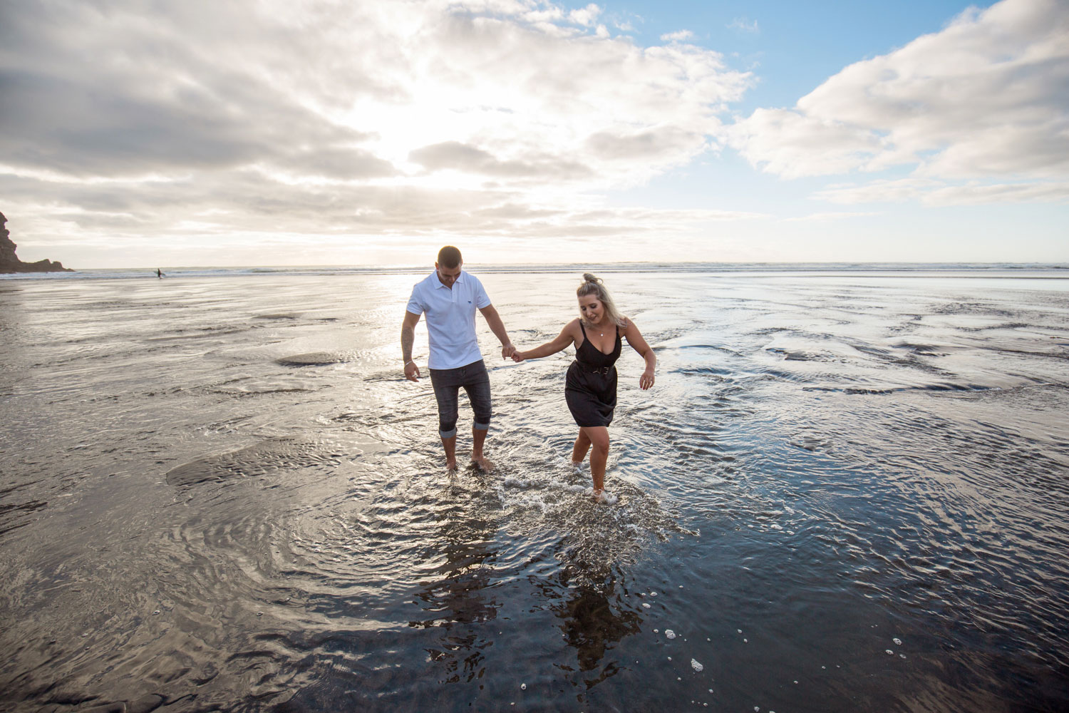 couple wading in water auckland