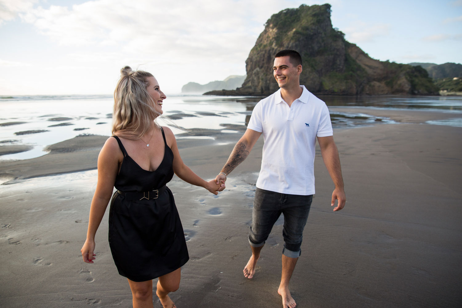 couple holding hands beach