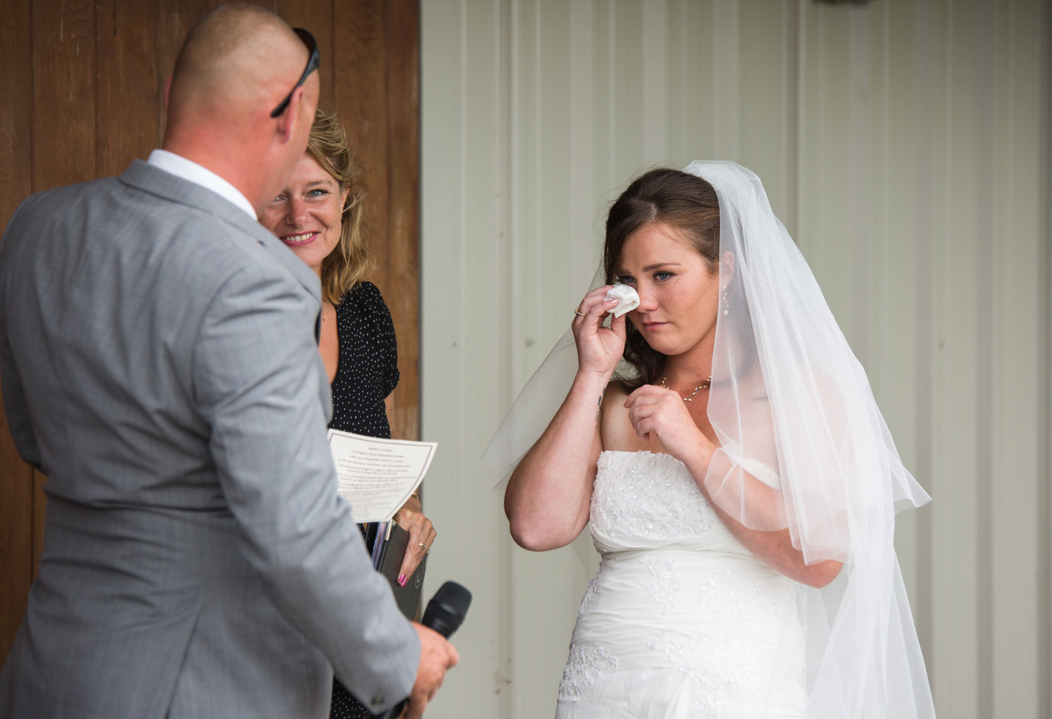 bride cries at barn wedding ceremony
