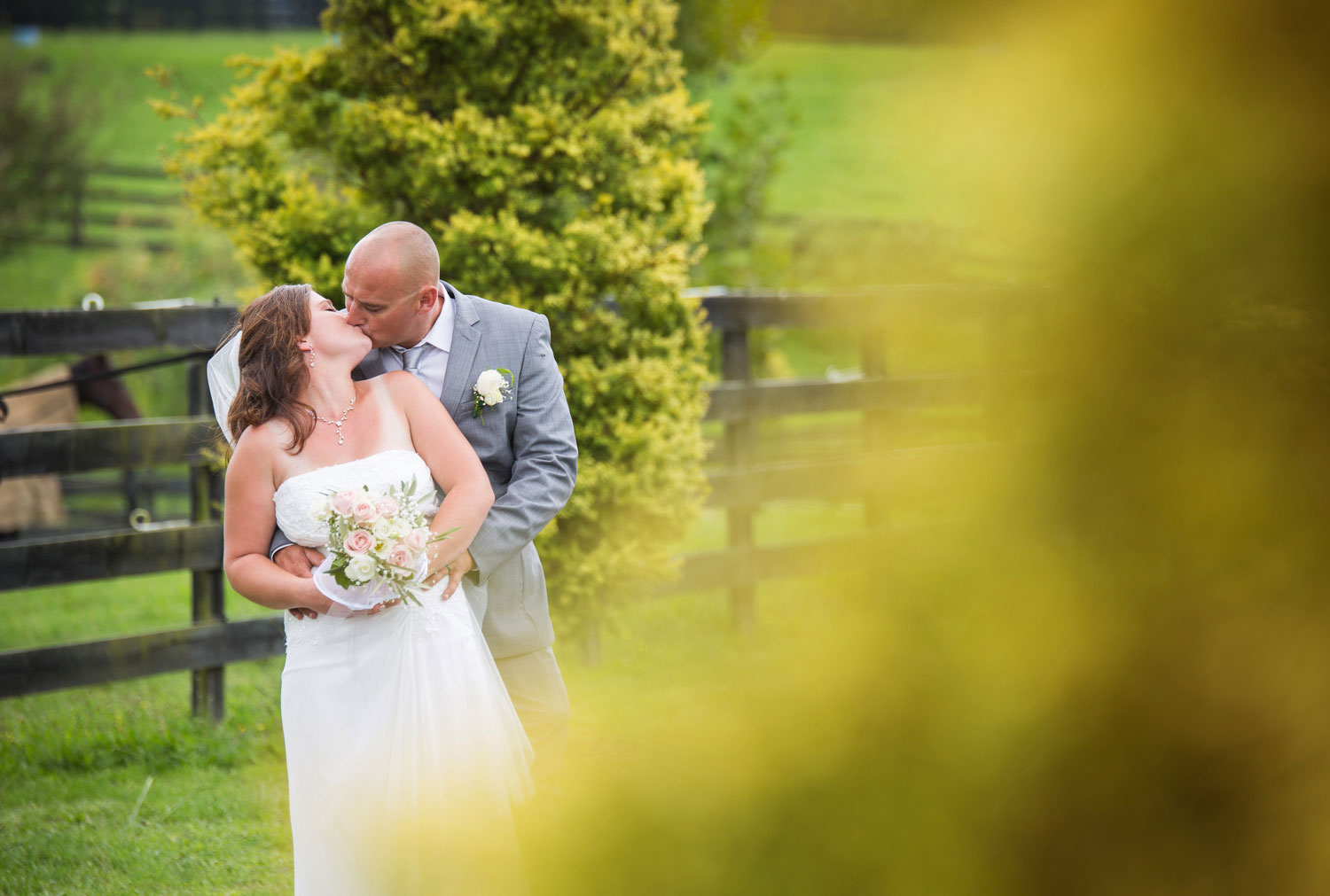 bride and groom kiss barn wedding