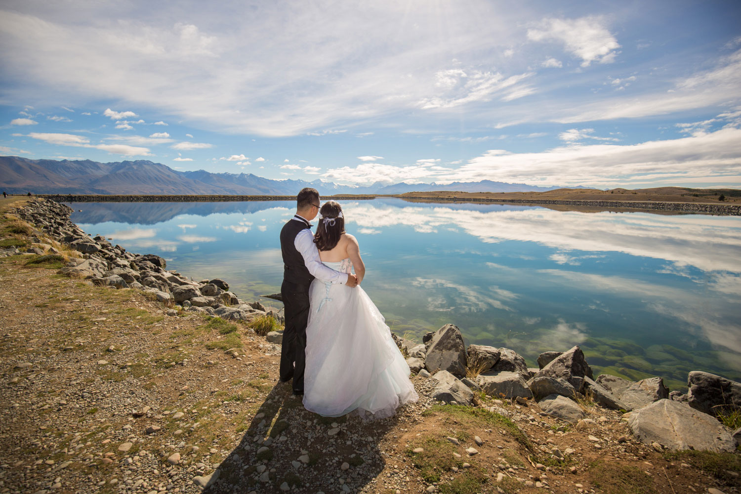 couple overlooking lake reflections