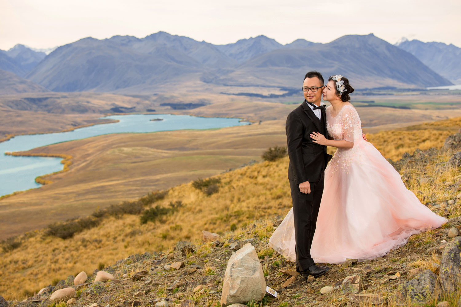 couple overlooking lake tekapo