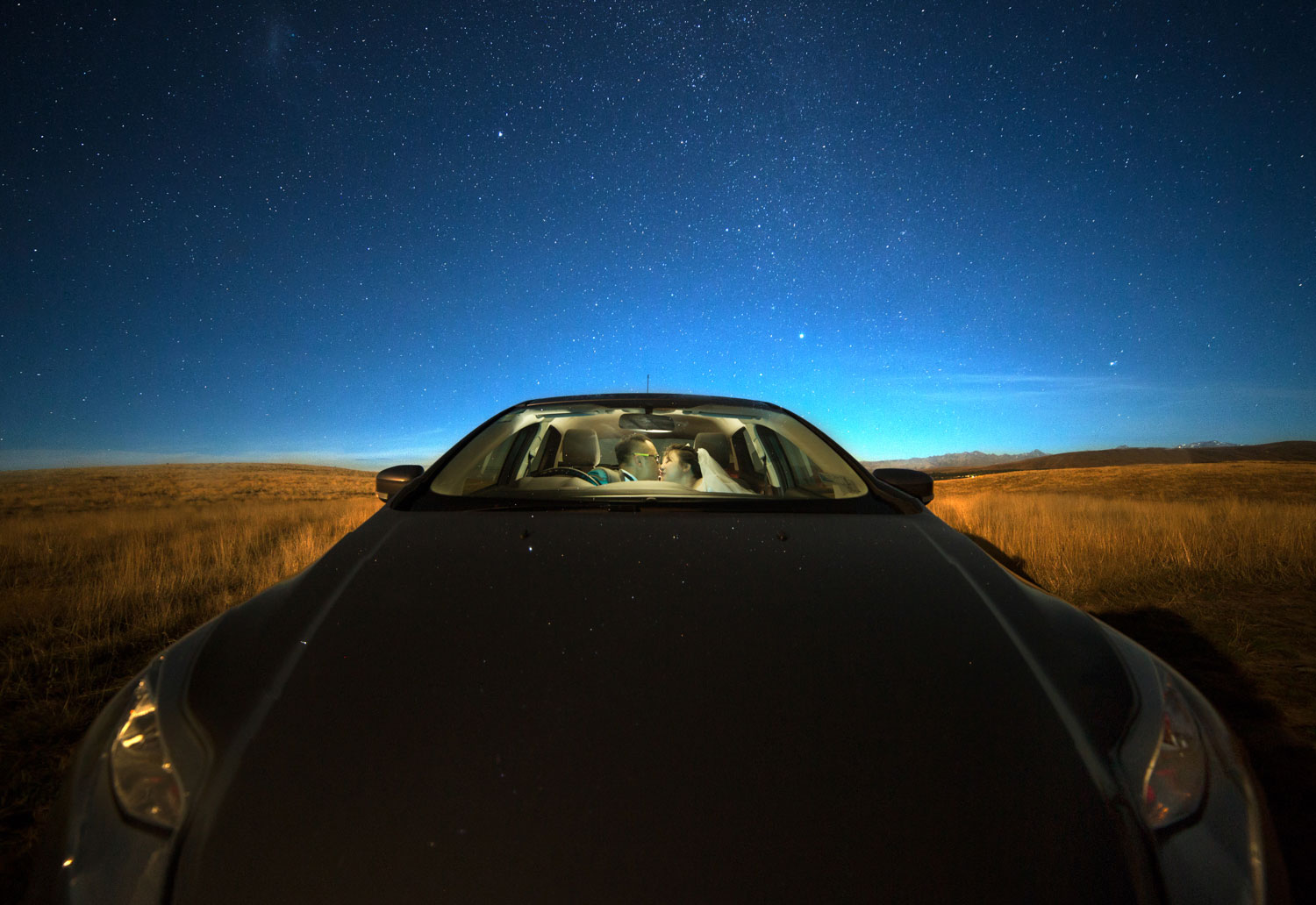 couple in car under milky way