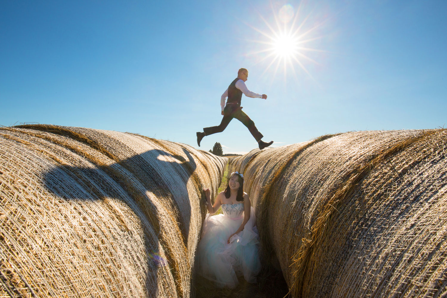 groom jumping over hay bale
