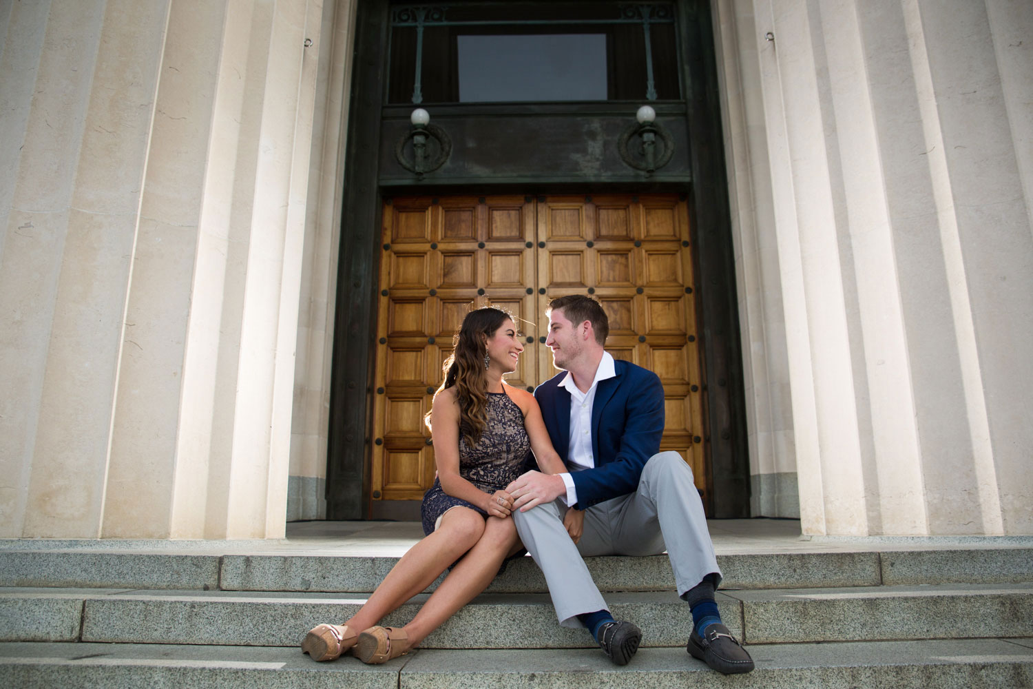 couple sitting in front of auckland domain museum