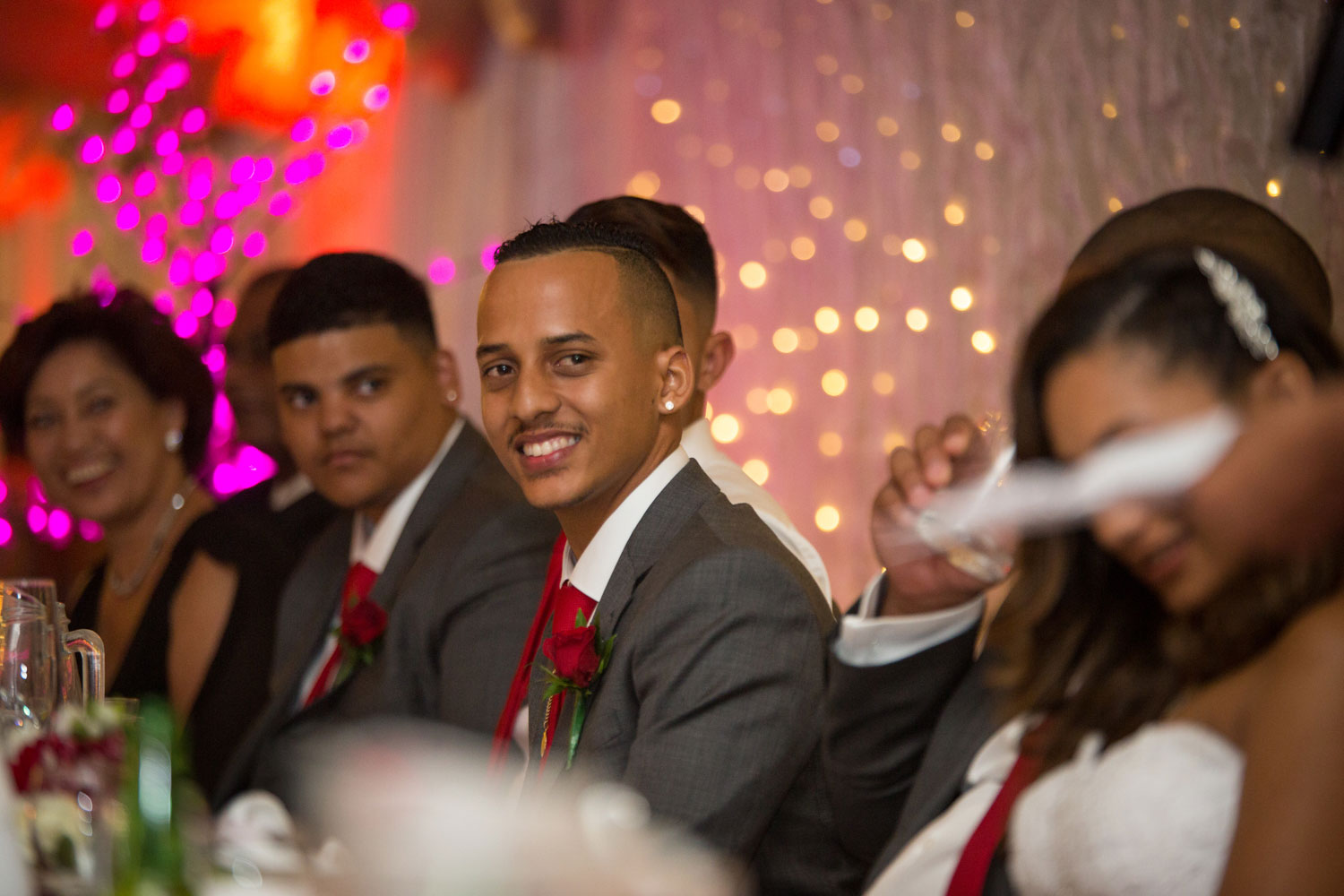 auckland wedding reception groomsman laughing at a guest's speech