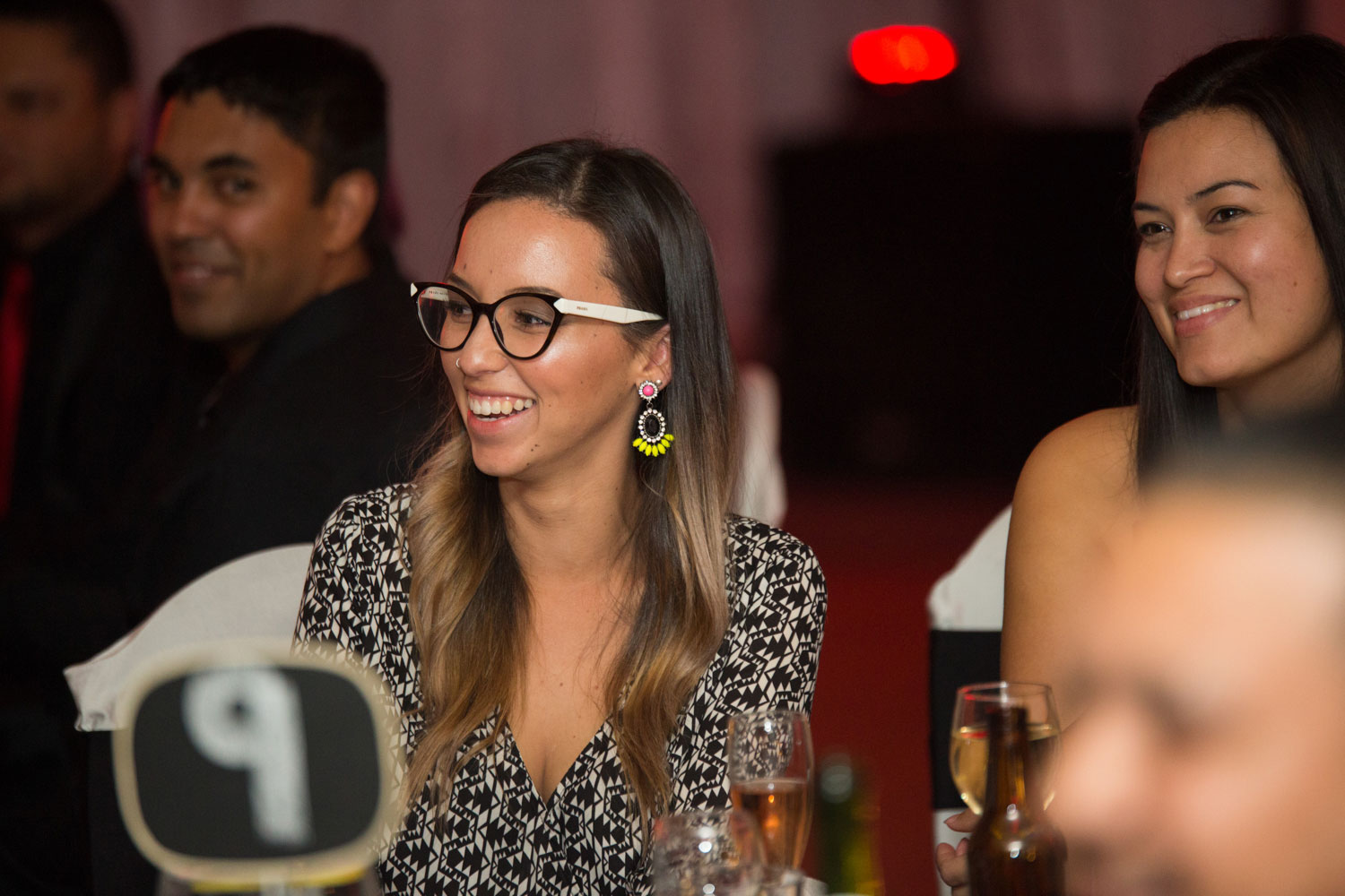 auckland wedding female guest sharing a joke with others