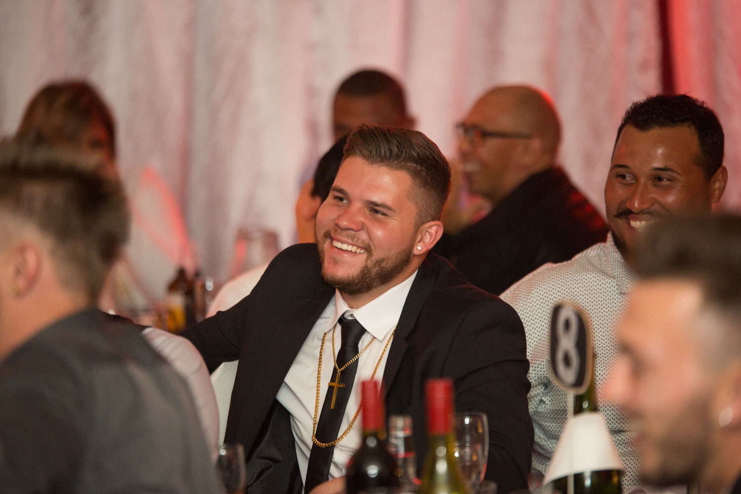 auckland wedding male guest laughing at someone else