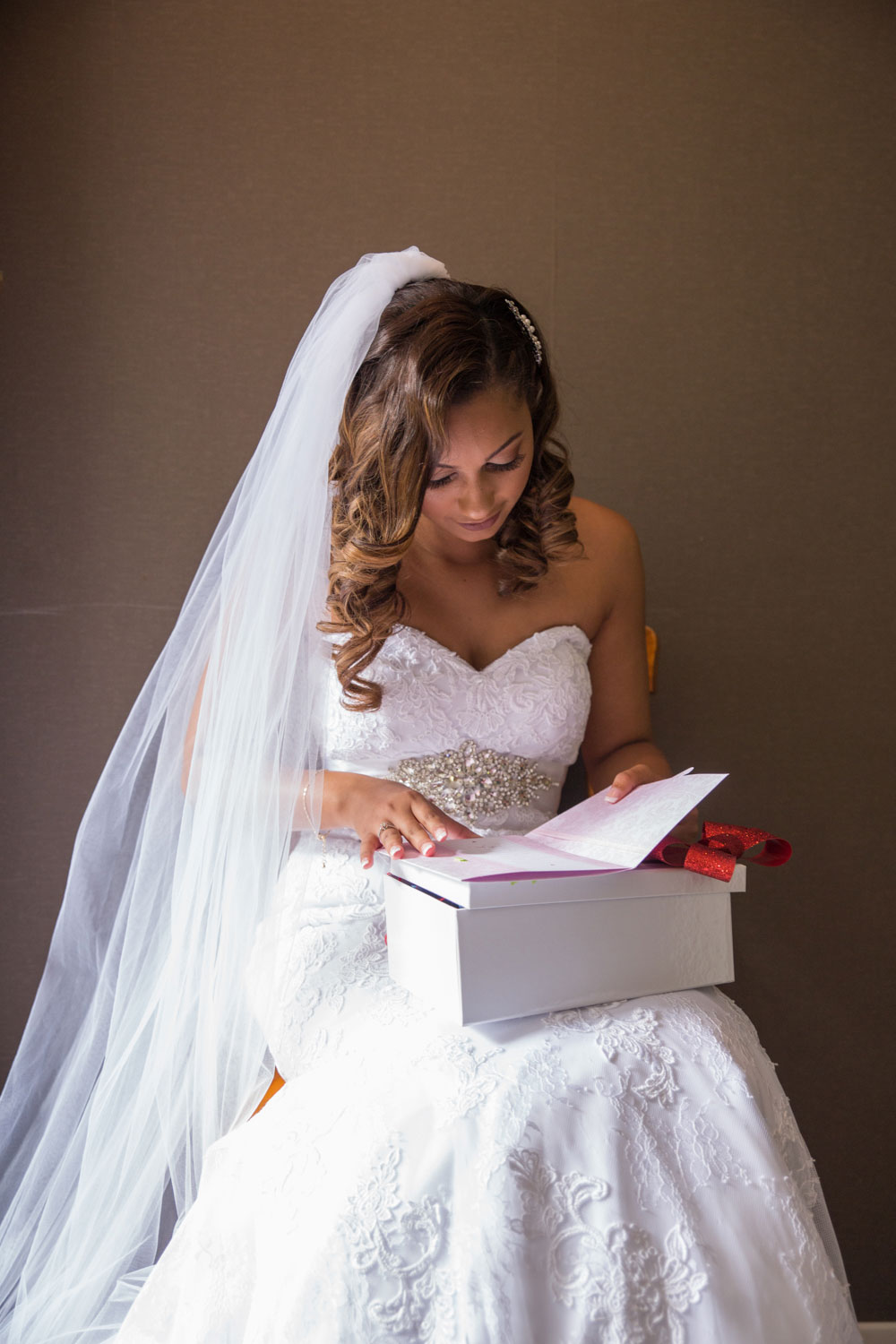 auckland wedding bride opening up gift from groom