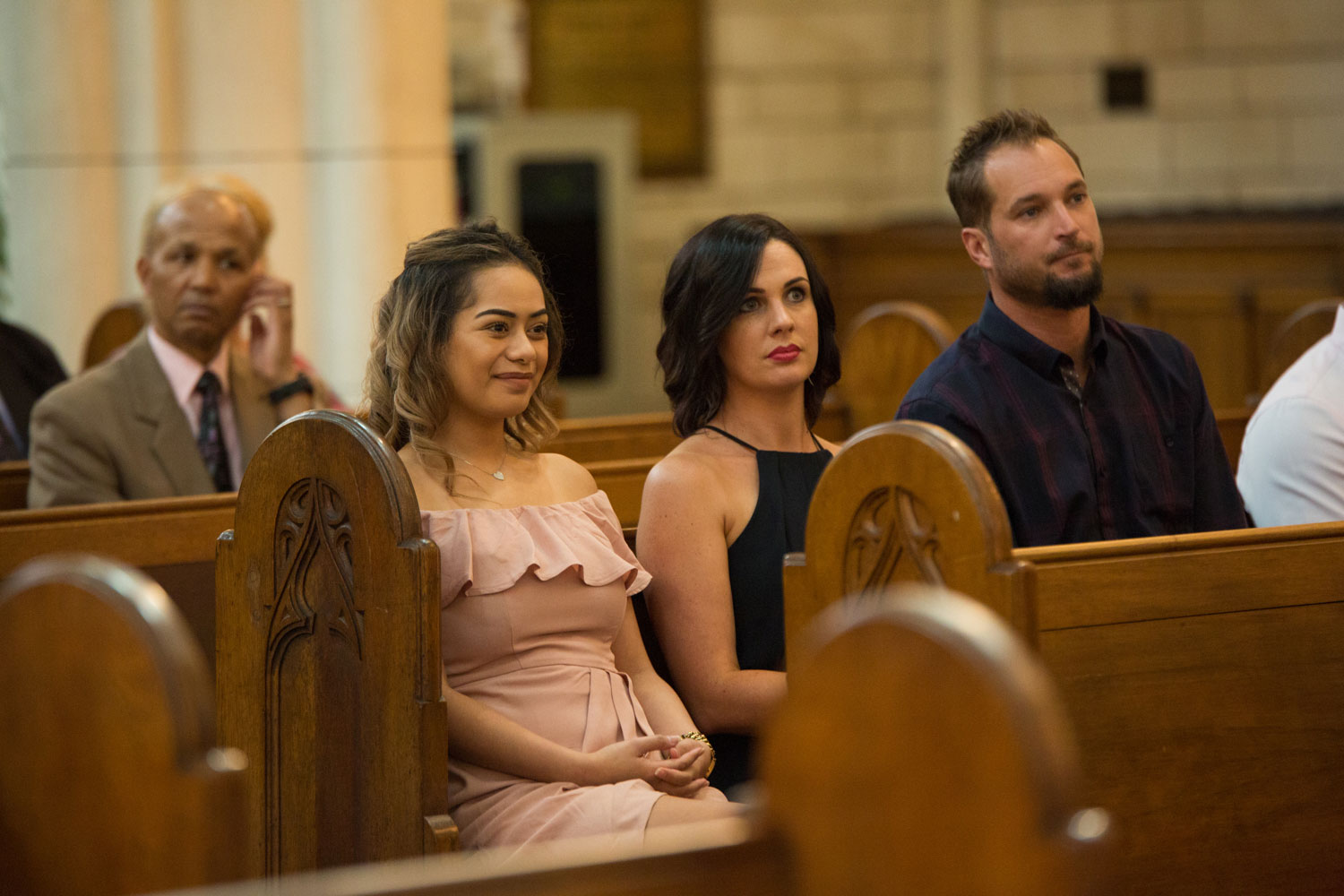 auckland wedding guest smiling in church