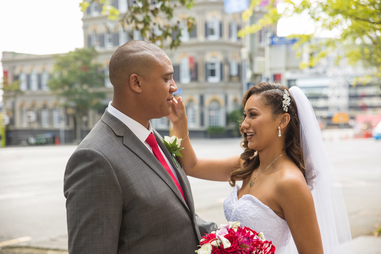 auckland wedding bride touching groom's face