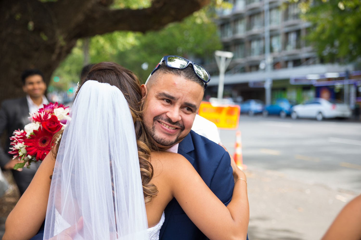 auckland wedding guest hugging bride