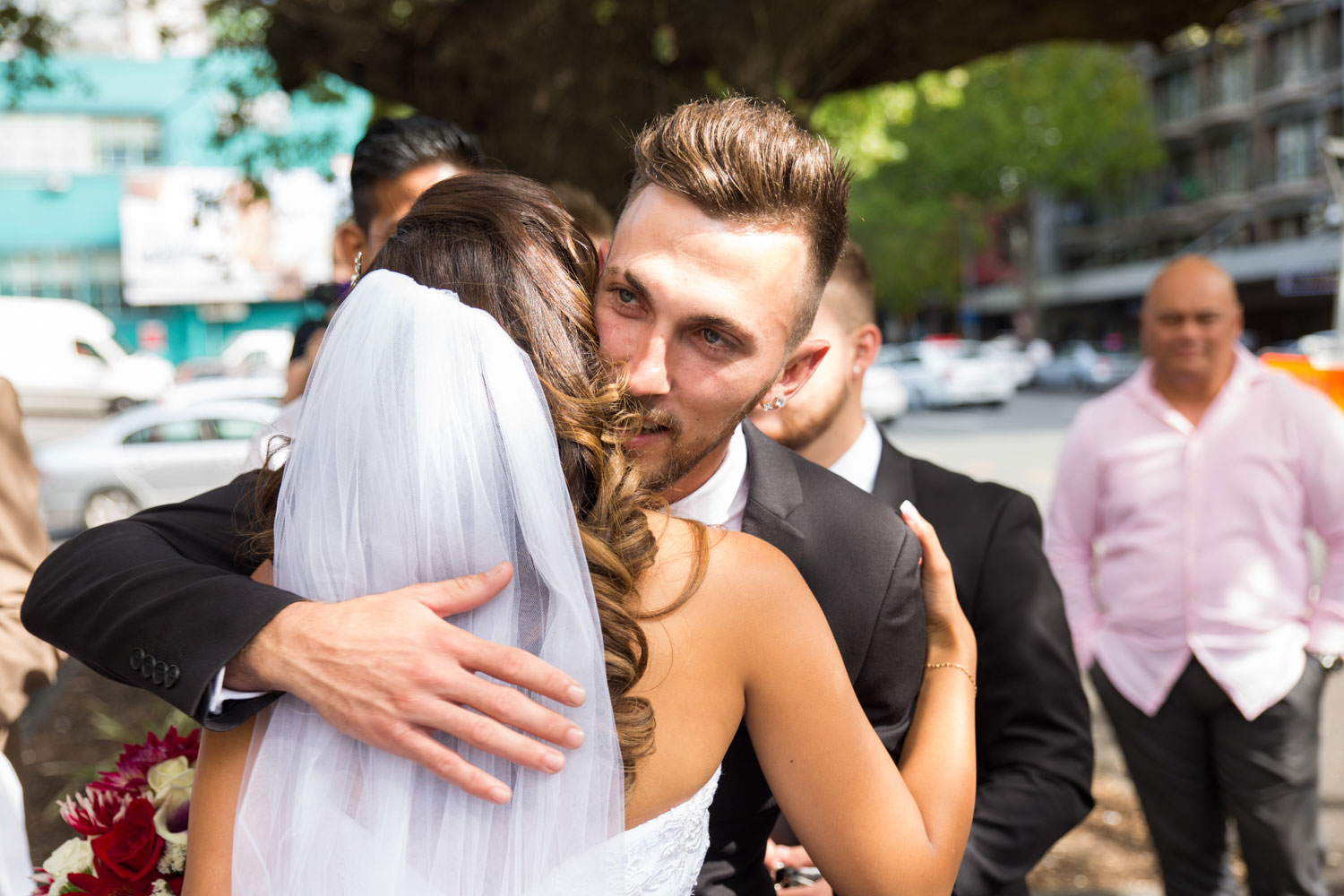 auckland wedding guest hugging bride