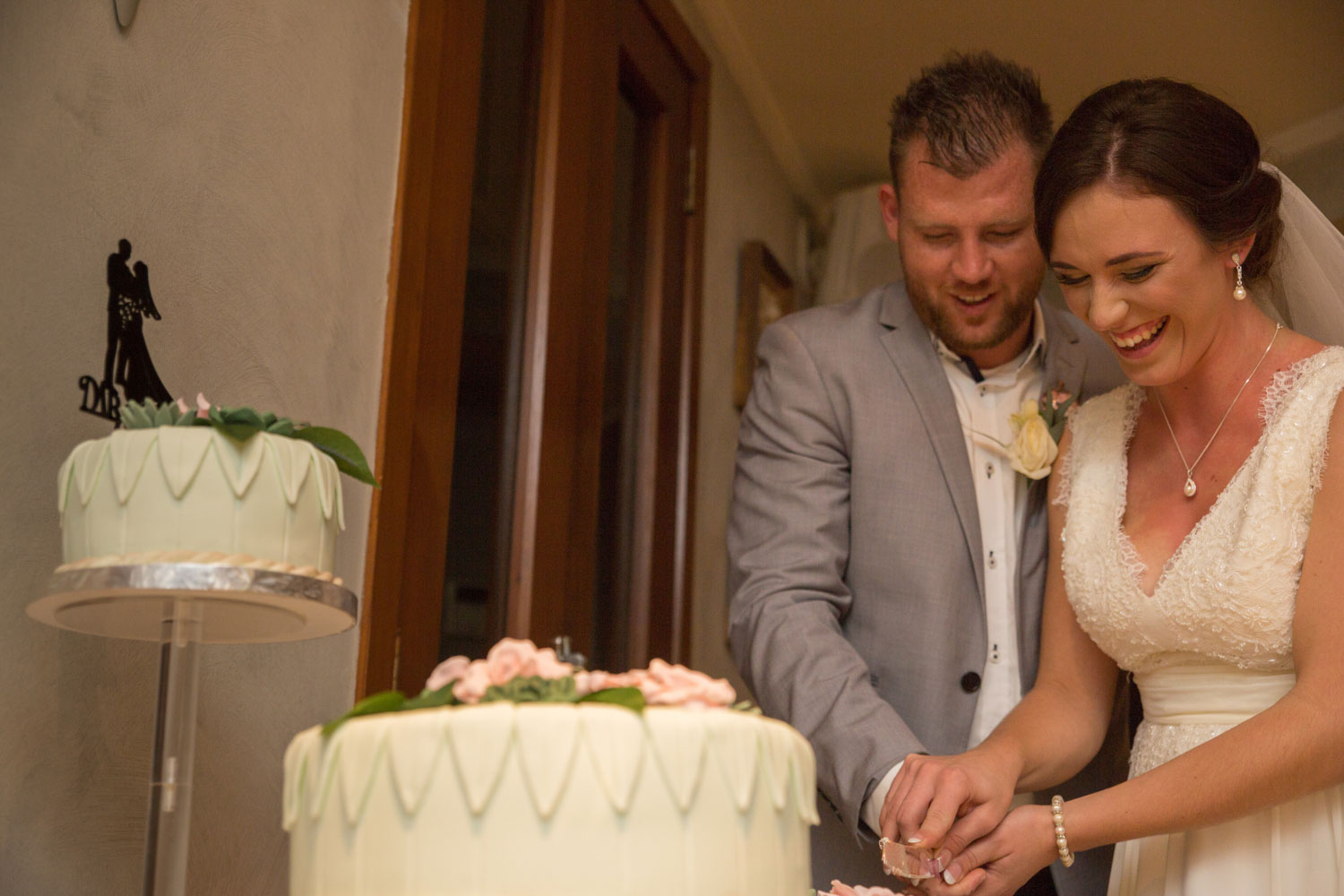 couple cutting cake at wedding reception