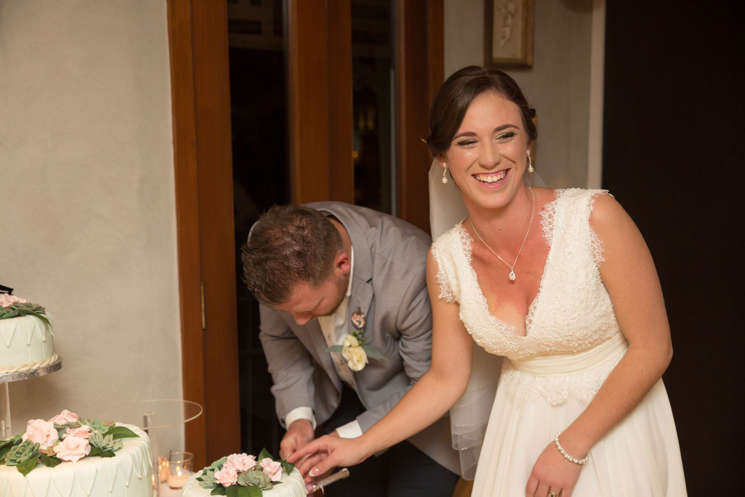 couple cake cutting wedding reception