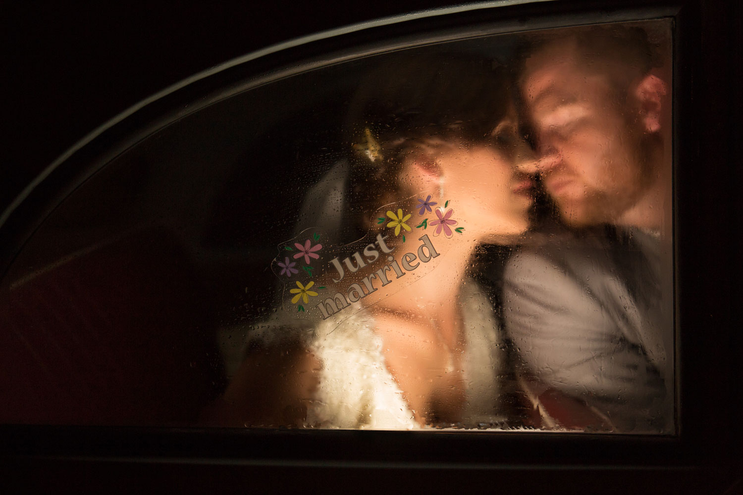 wedding photo of couple in car