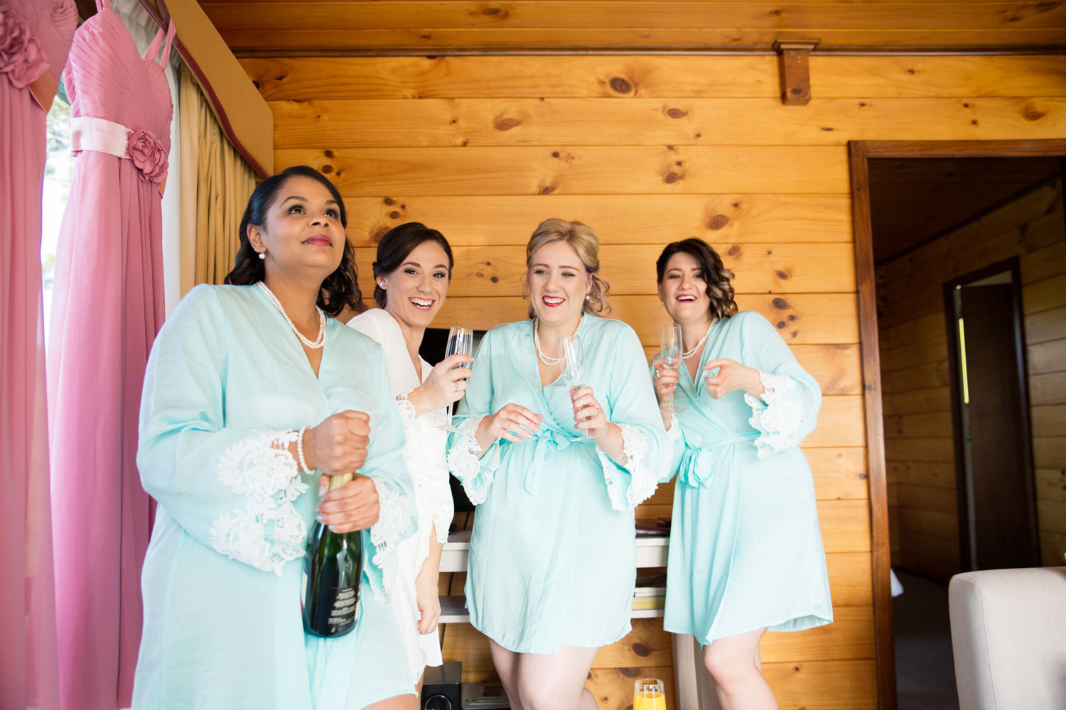 bridal party popping champagne