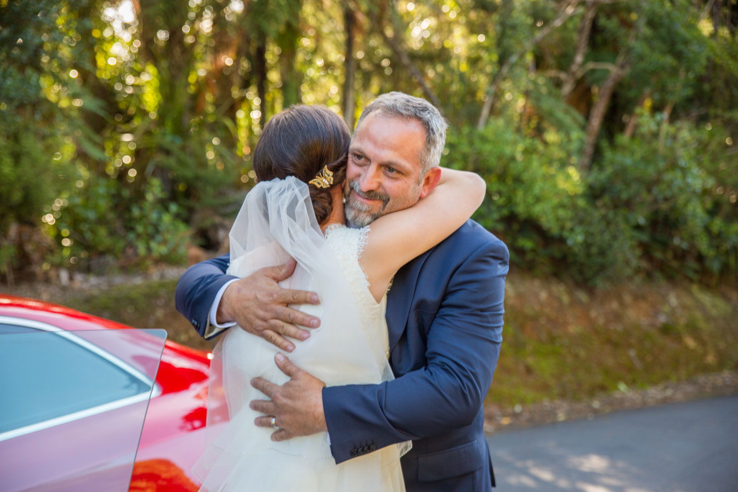 father hugging the bride