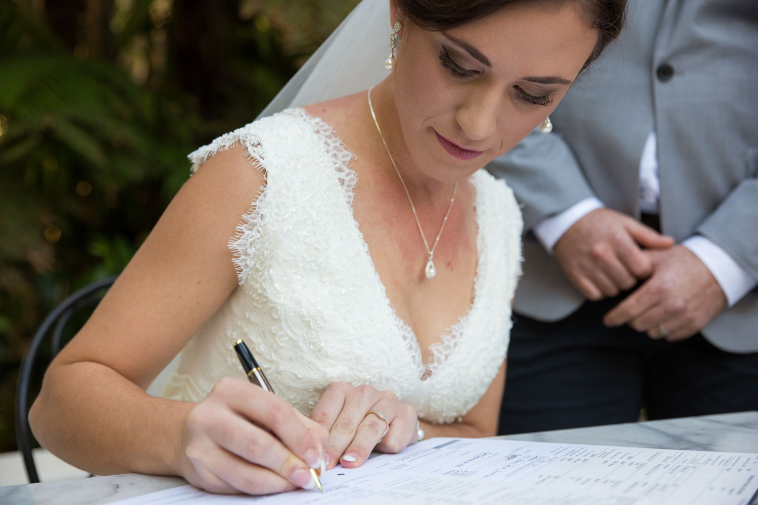 bride signing papers wedding ceremony