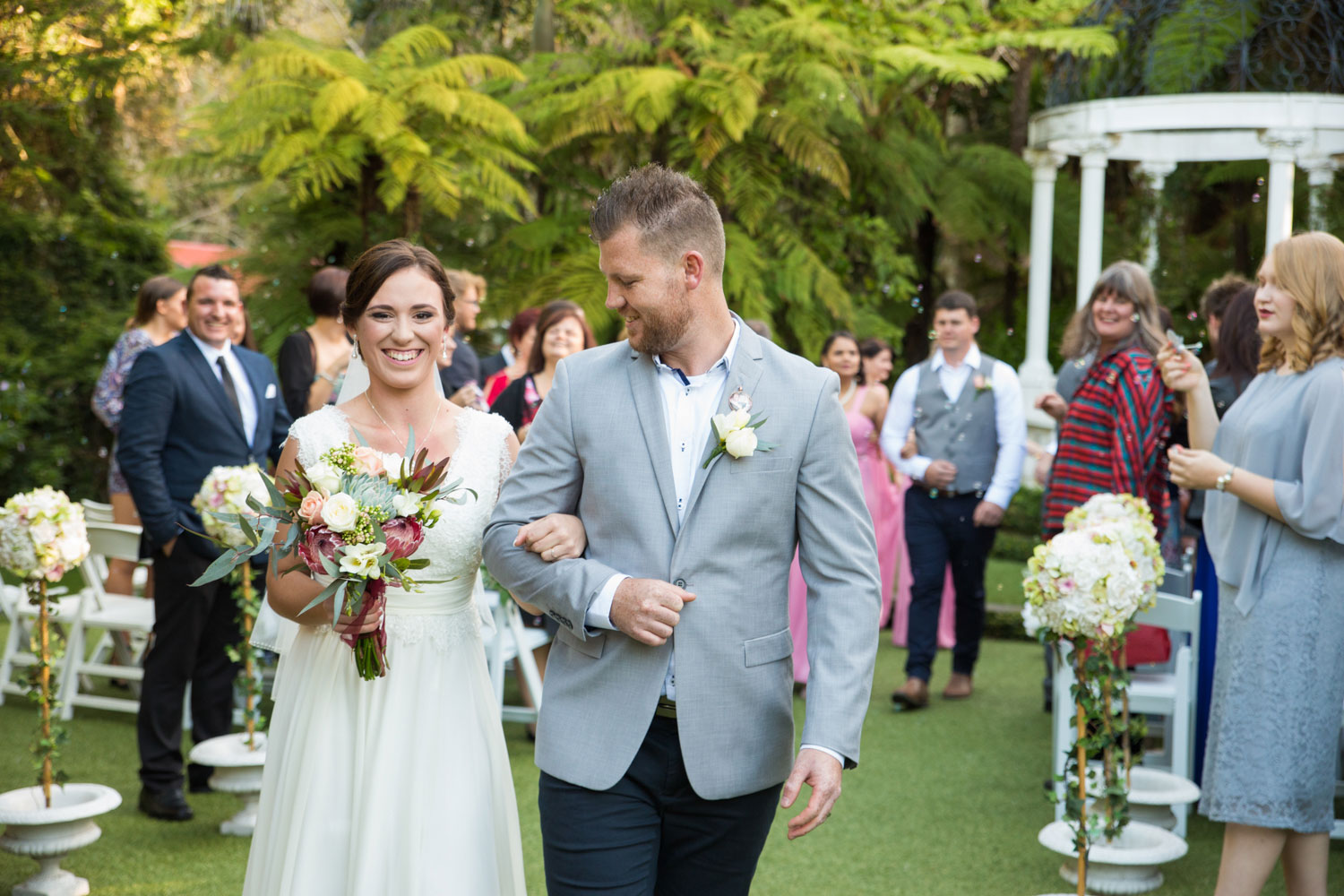 bride and groom leaving ceremony venue