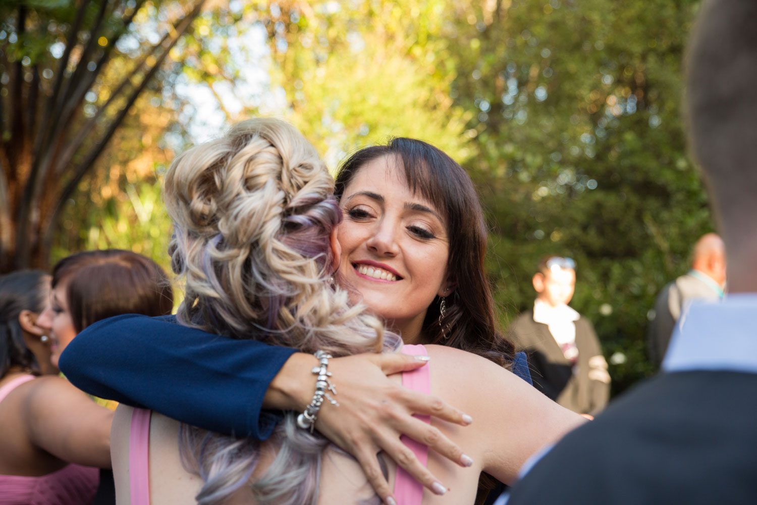 guest hugging bridesmaid