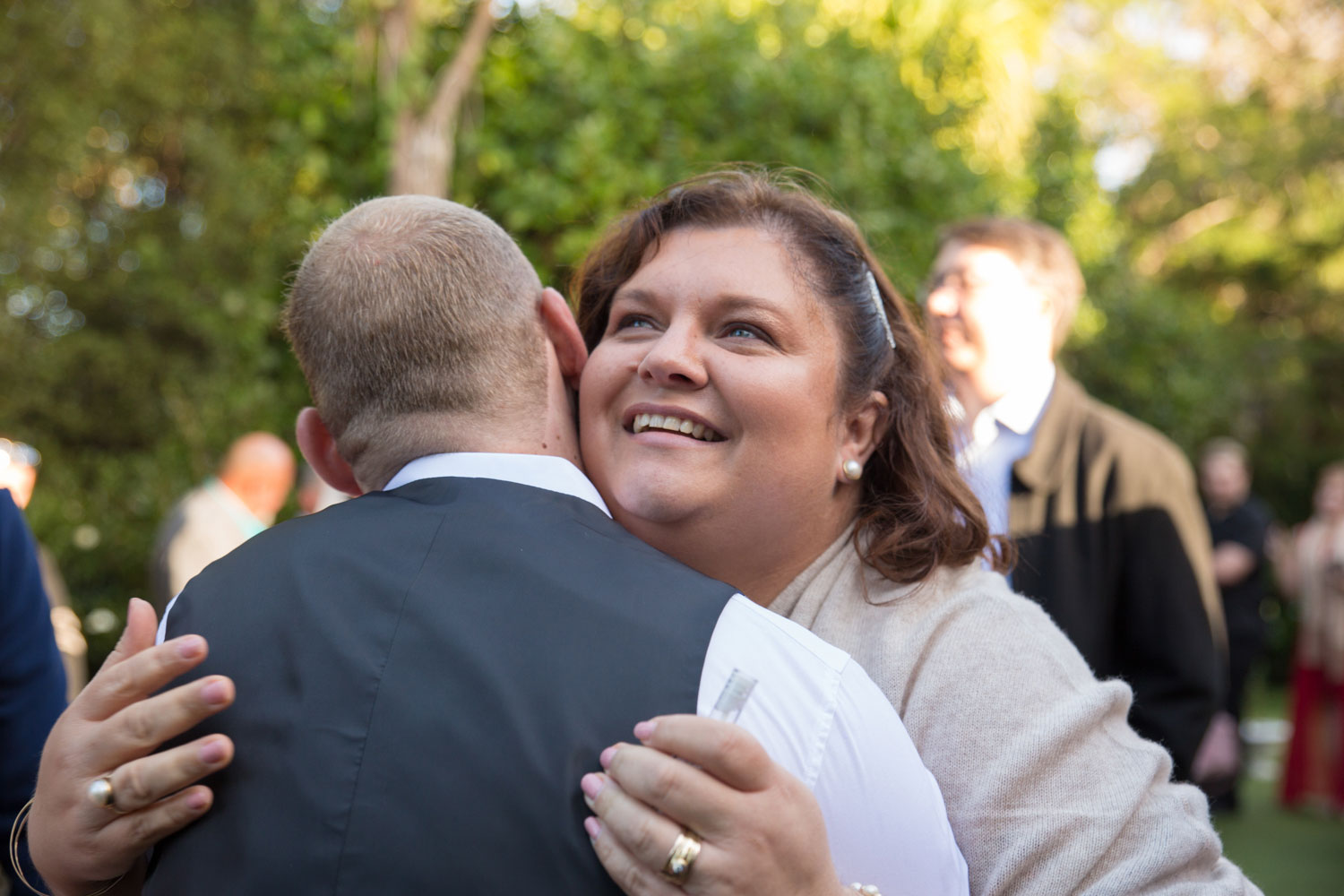 wedding guest hugging groomsman