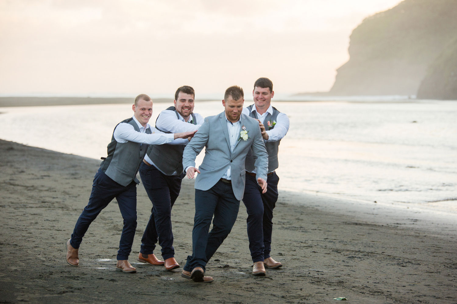 the boys having fun on bethells beach