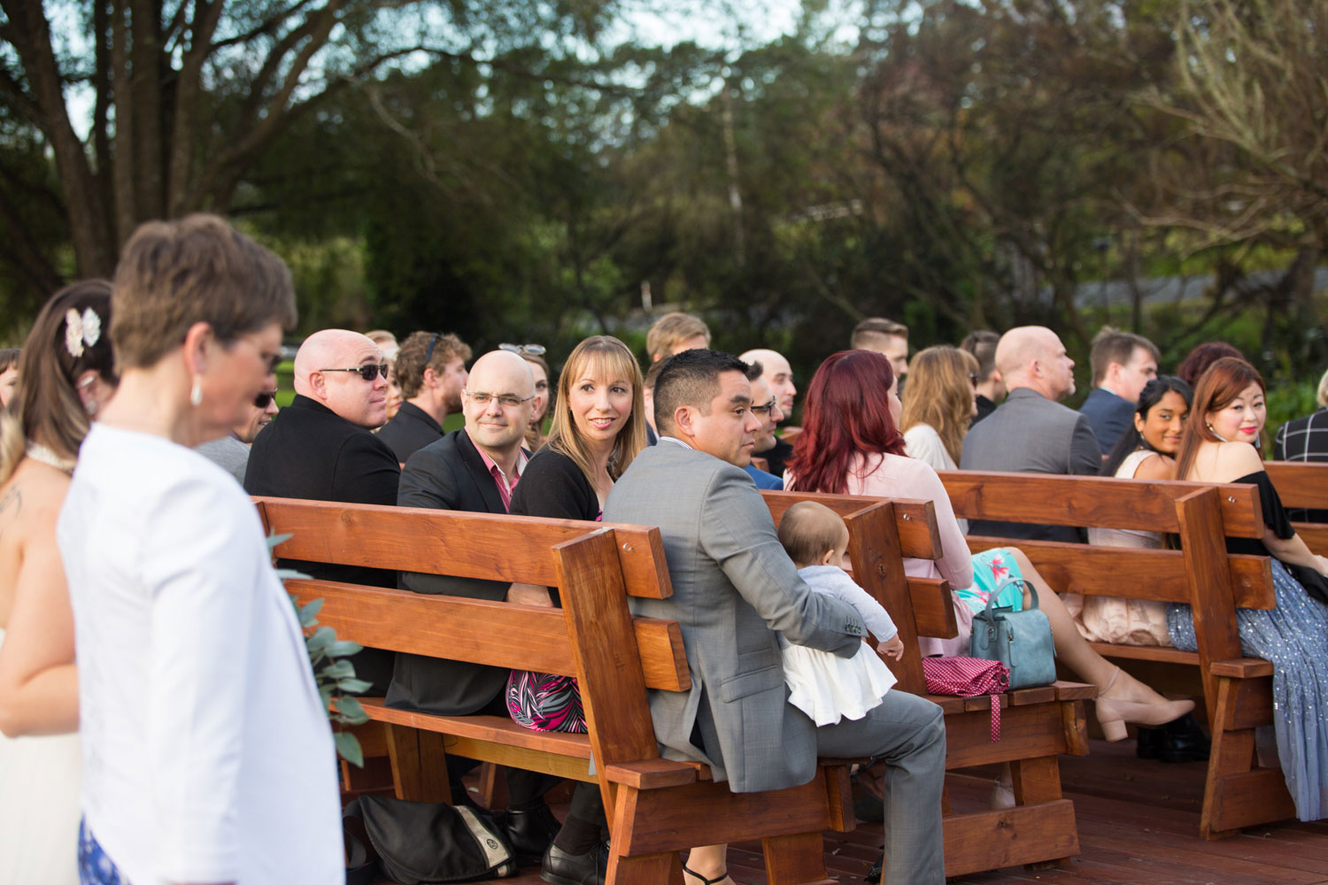 guest look at bride walking down aisle