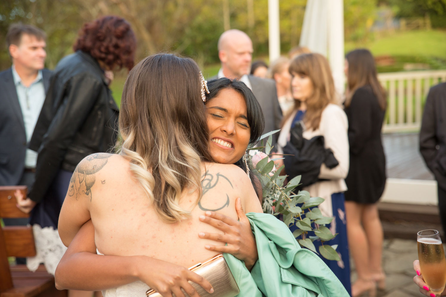 guest hugging bride at auckland wedding