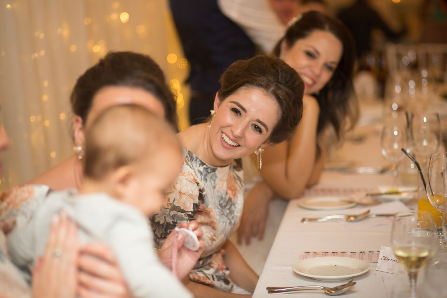 bridesmaids and baby laughing at wedding reception gracehill auckland wedding