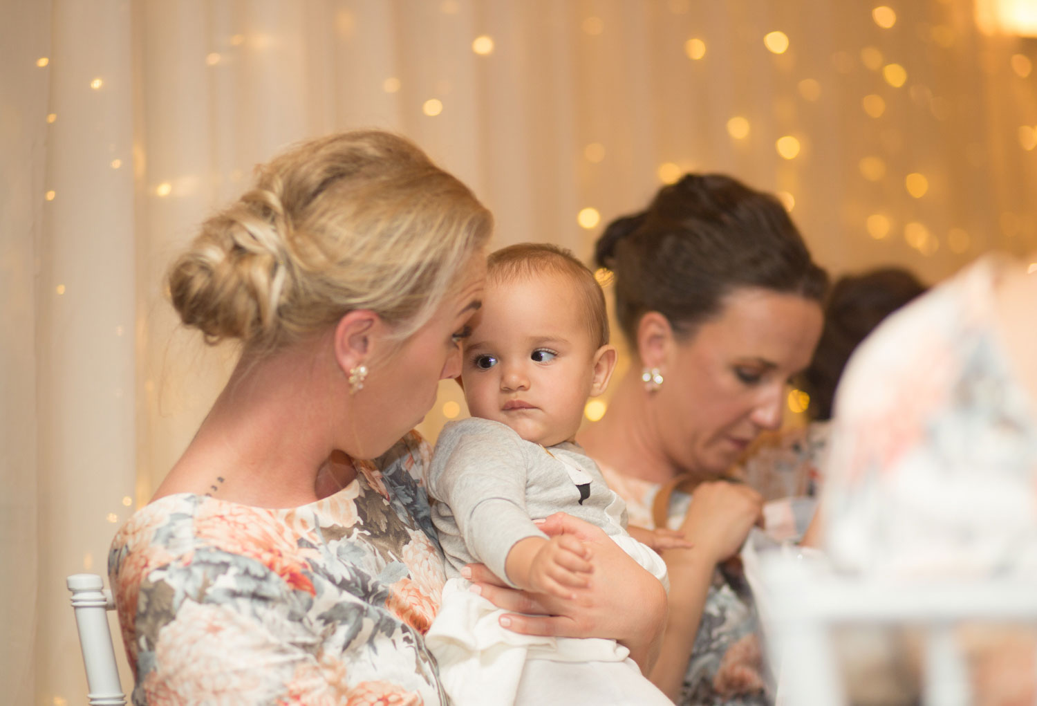 baby and bridesmaid during wedding