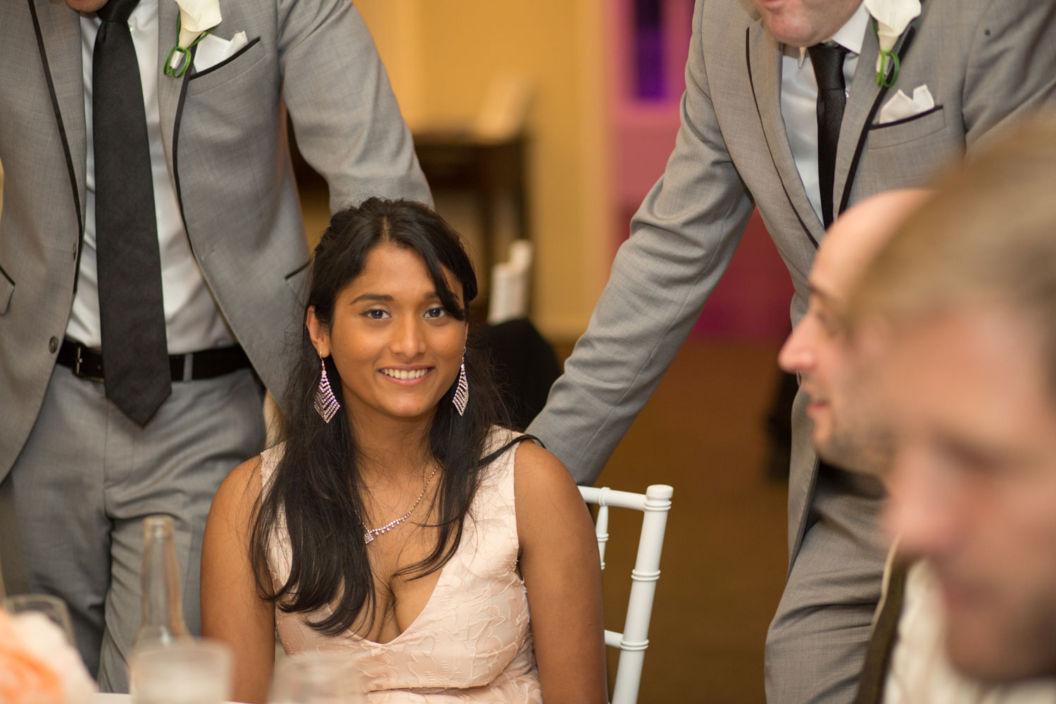 wedding guest smiling at the camera