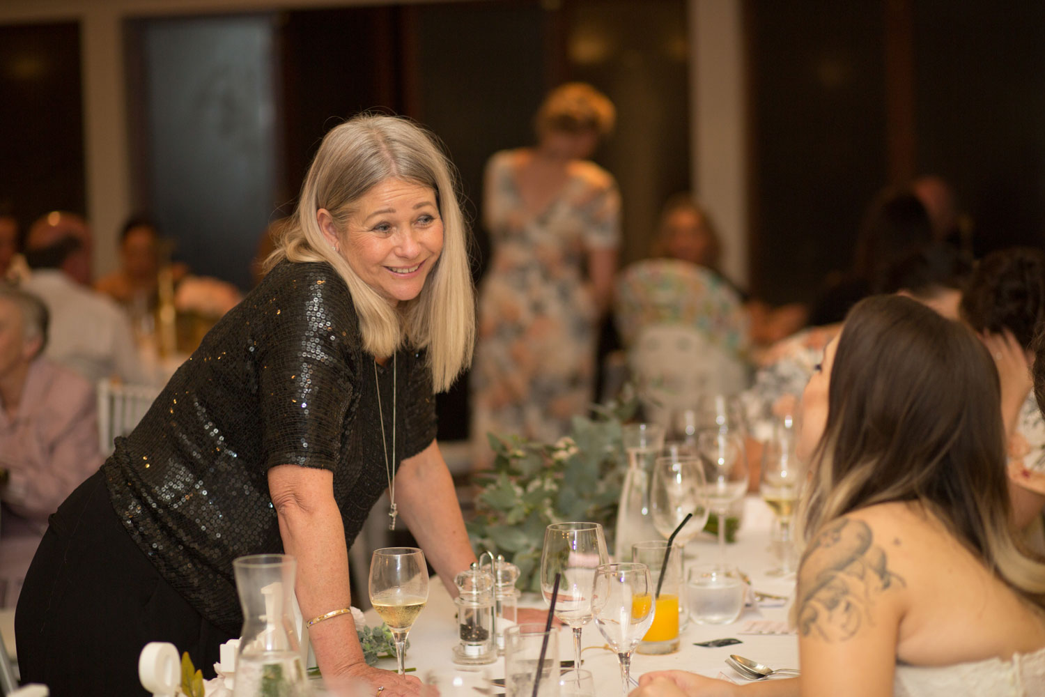 guest chatting with the bride during reception