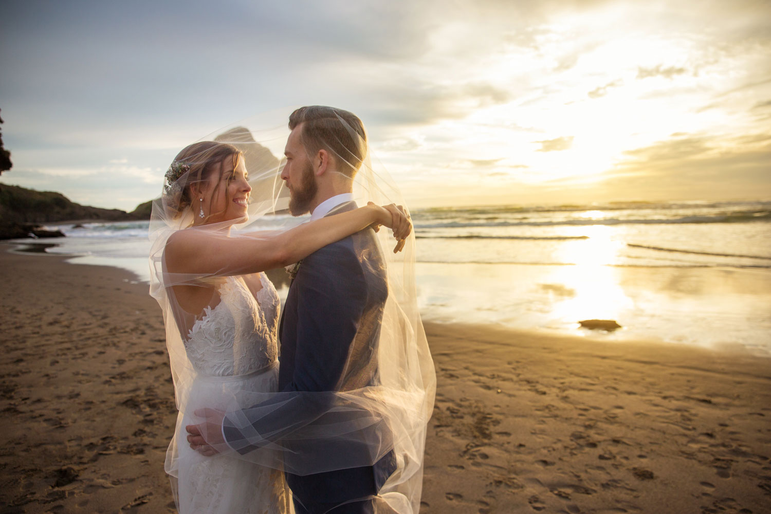 auckland wedding couple embrace under the veil