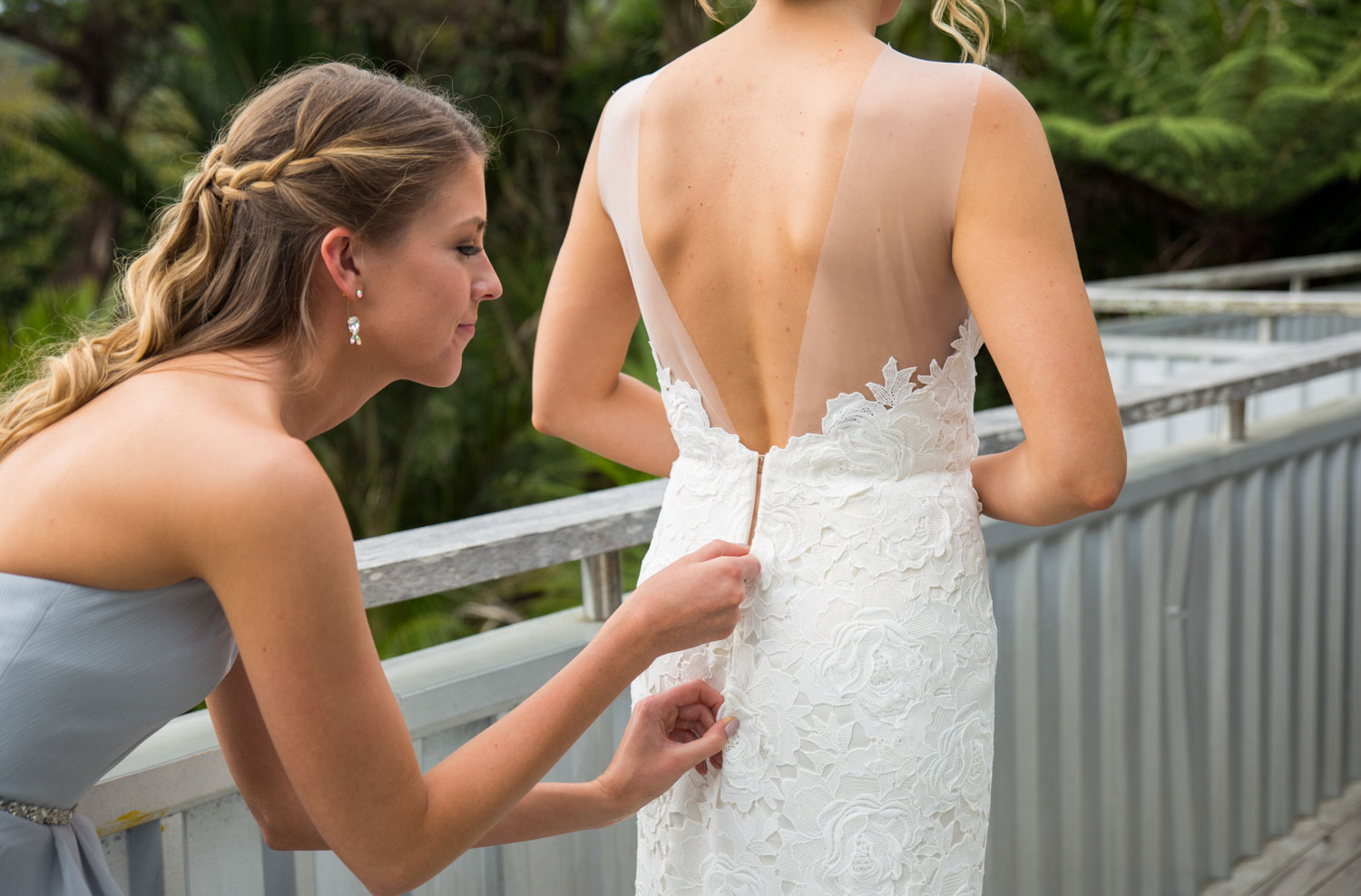auckland wedding maid of honor putting on dress