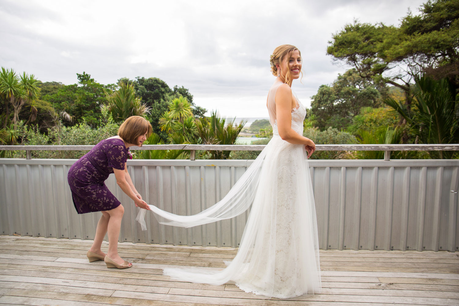auckland wedding mother helping bride with dress
