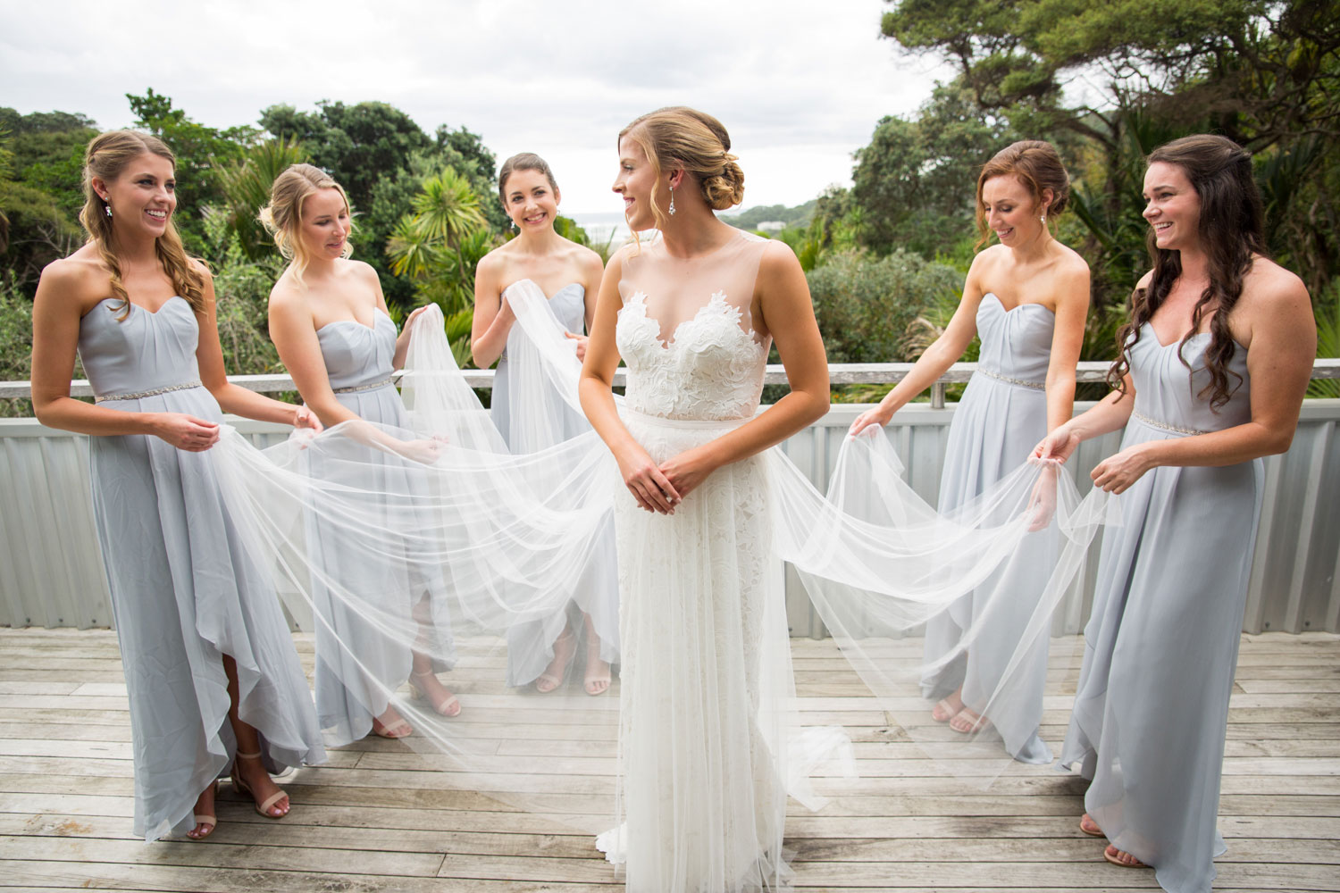 auckland wedding bridesmaids helping with the dress