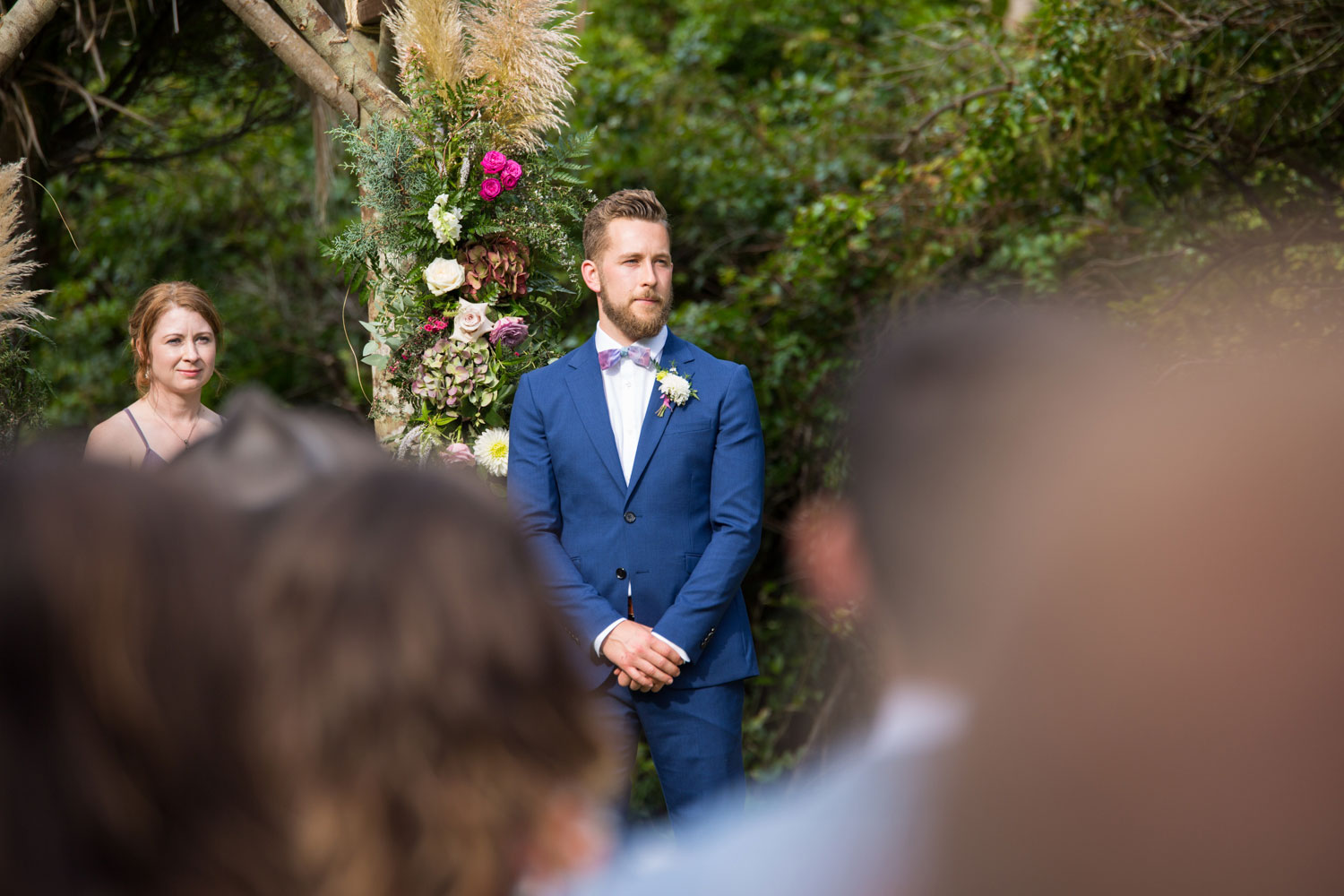 auckland wedding groom looks on