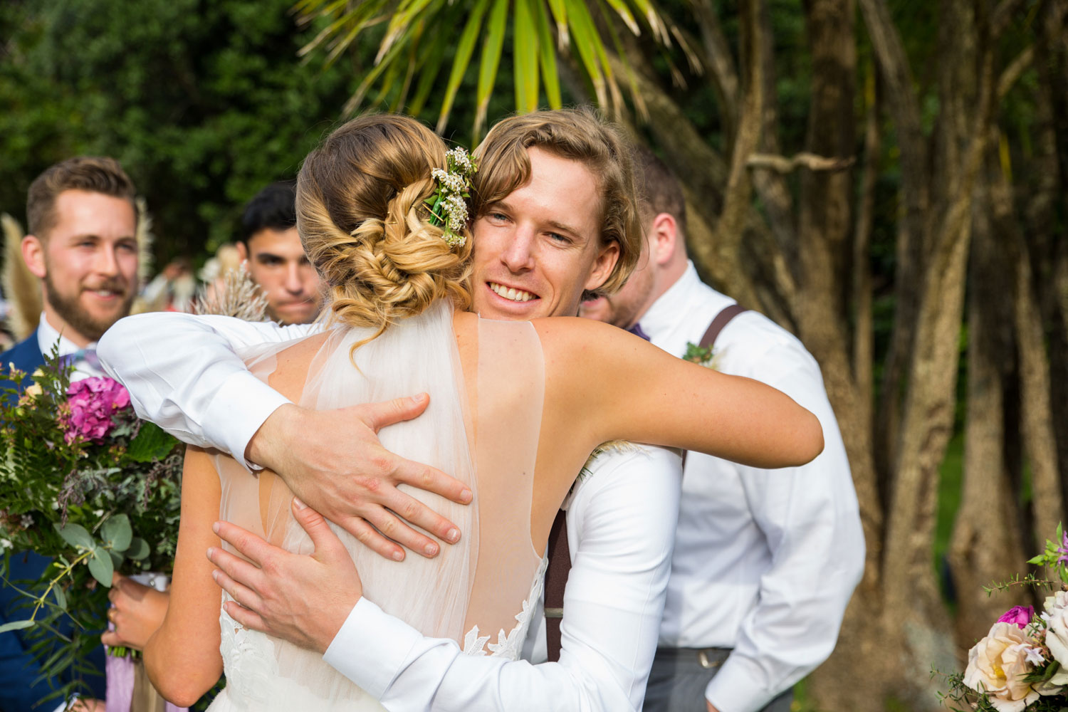 auckland wedding groomsman hugs bride
