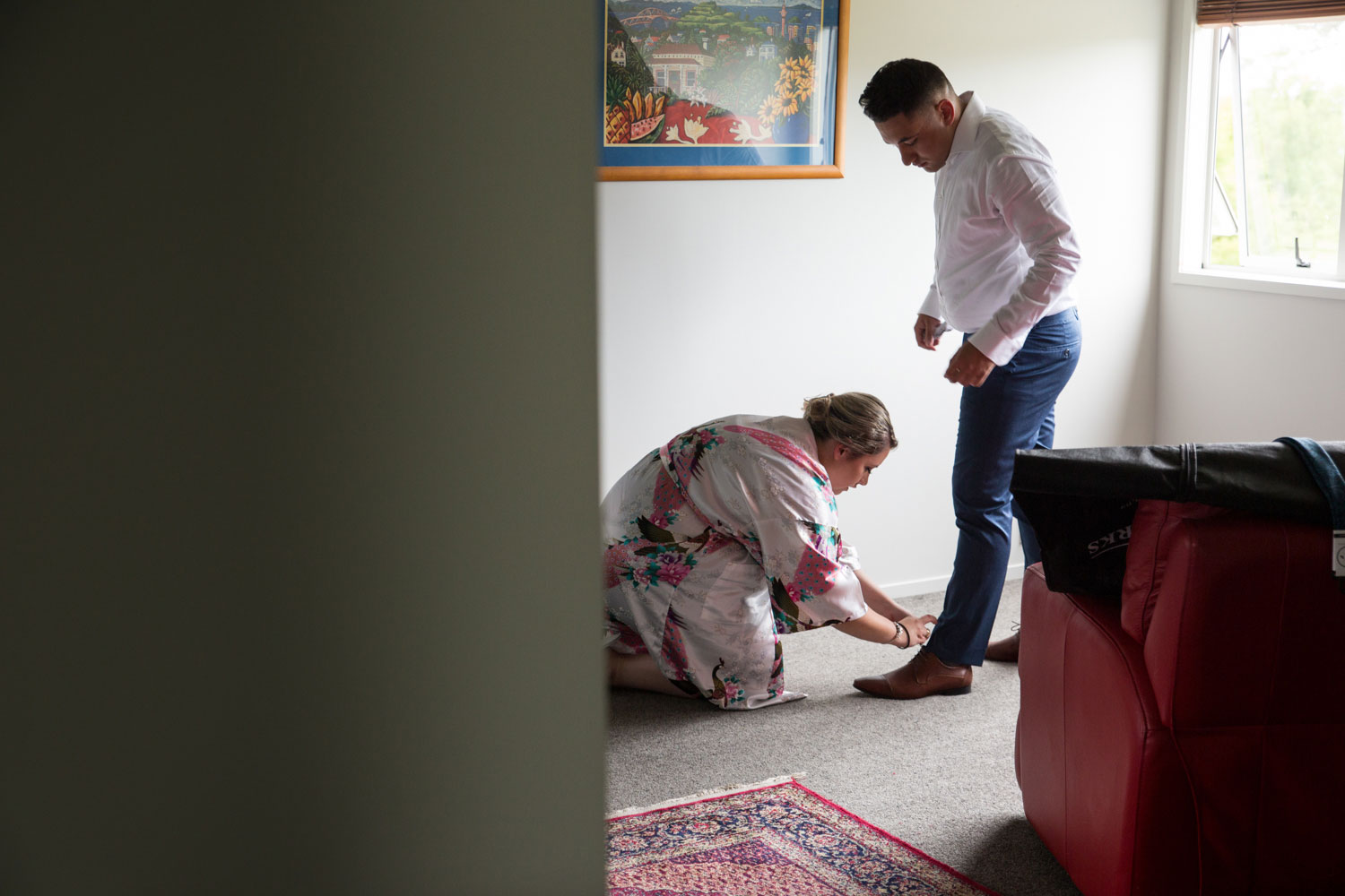 auckland wedding bridesmaid helping groom