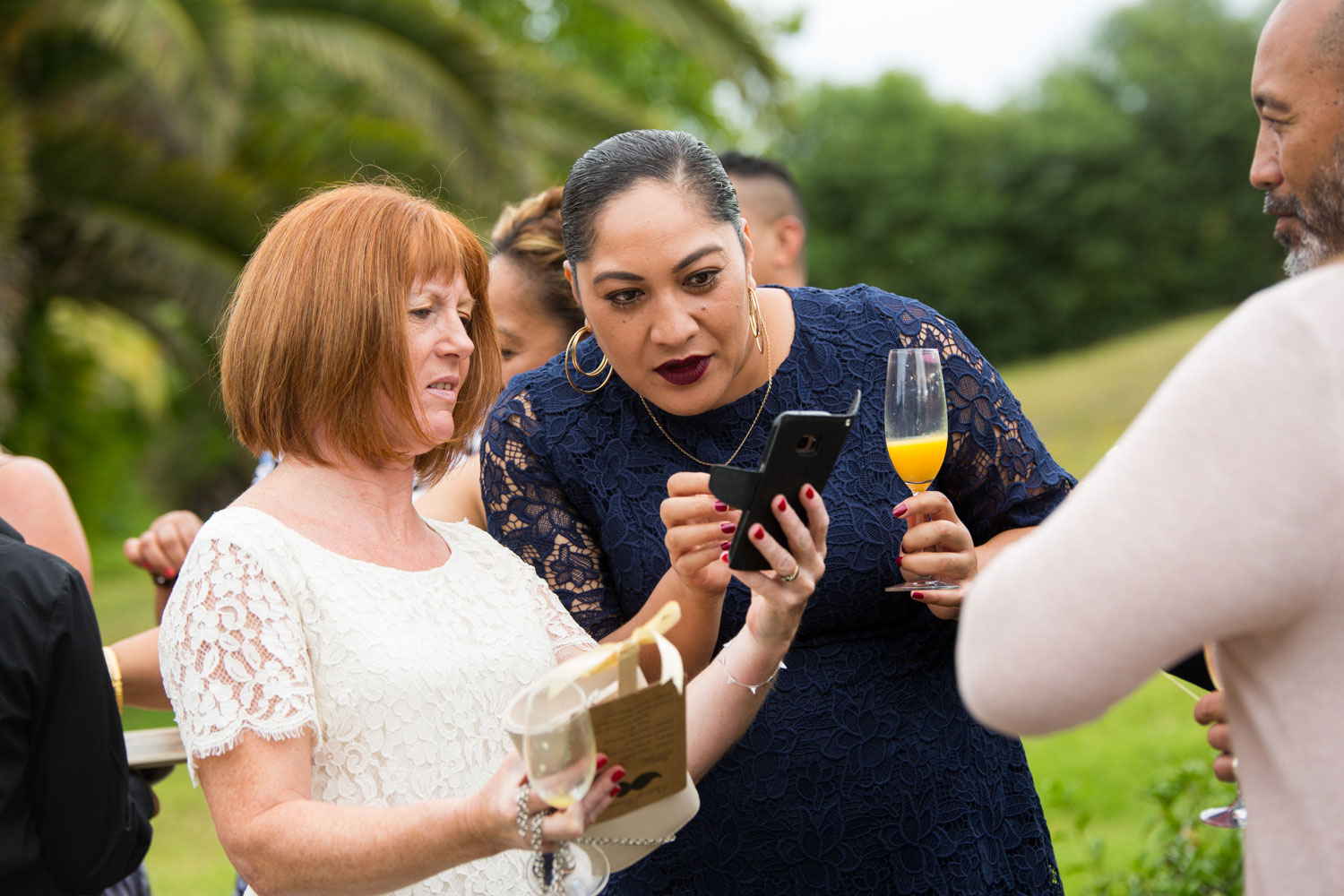 gracehill auckland wedding guests looking at phone