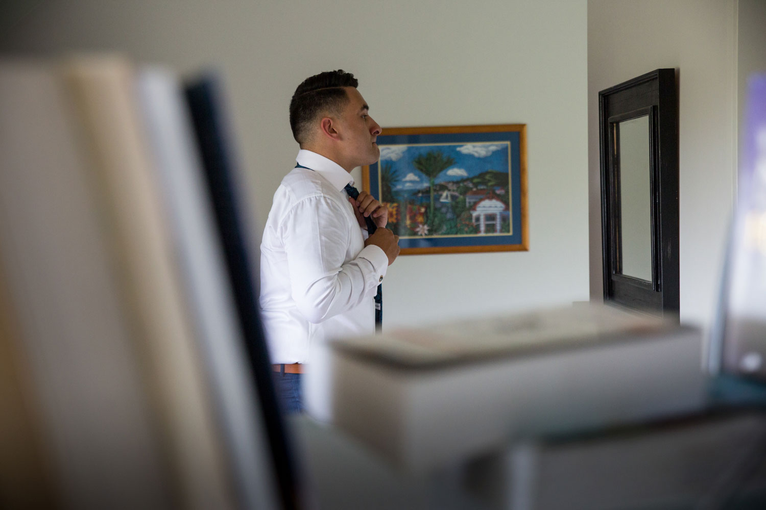 auckland wedding groom putting on tie