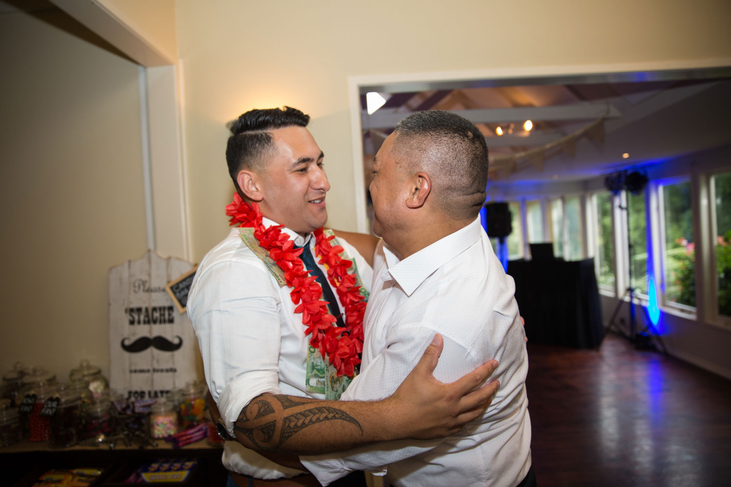 gracehill auckland wedding groom and guest embrace