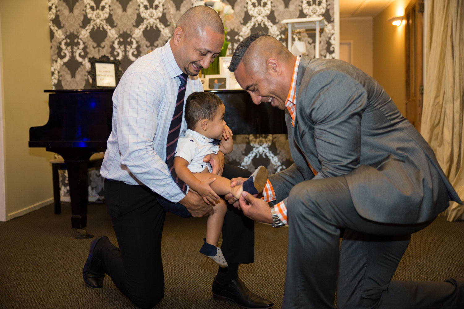 gracehill auckland wedding guests helping boy put on shoes