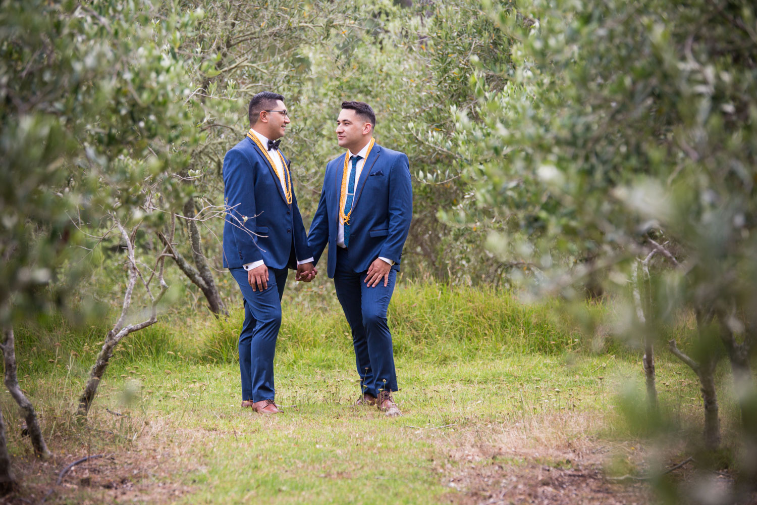 auckland wedding grooms looking at each other